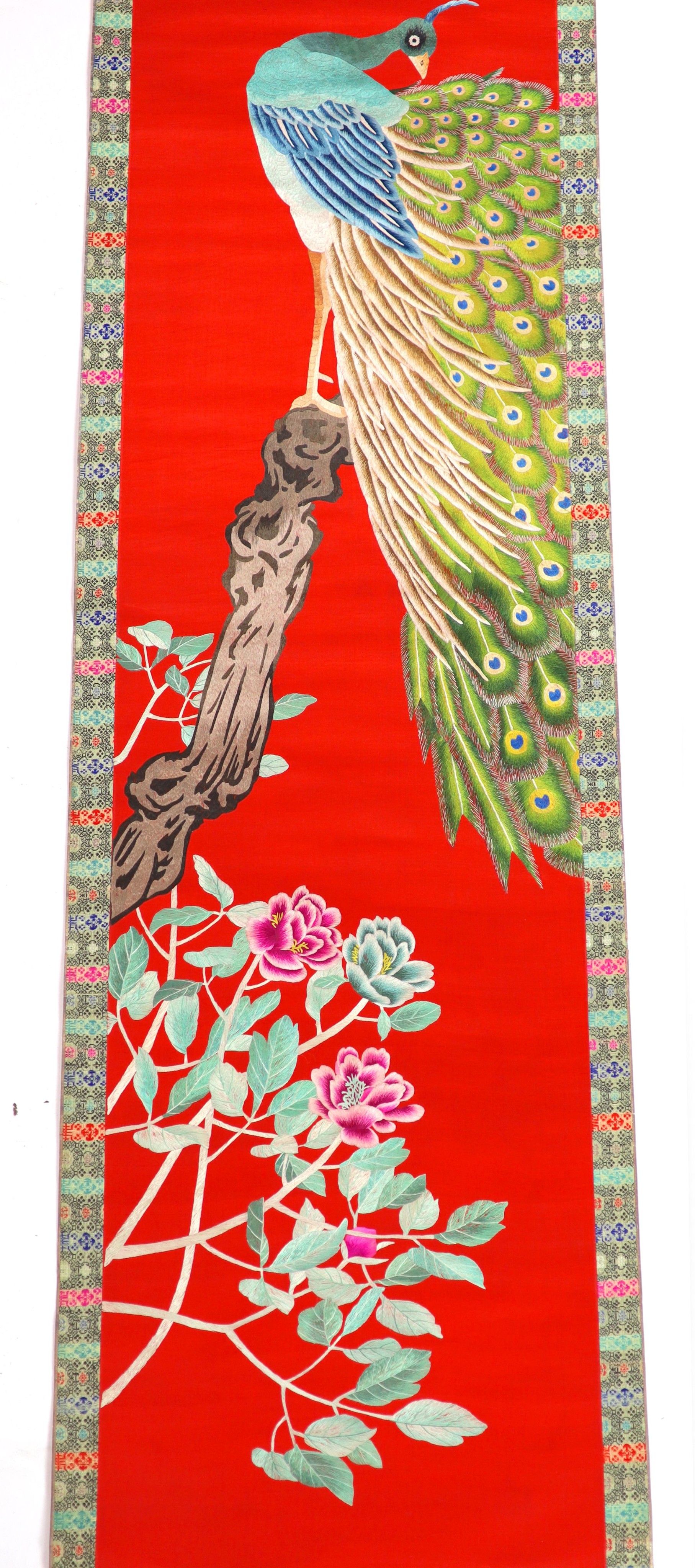 A Chinese embroidered silk ‘peacock’ scroll, late 19th century, 194 x 45 cm excluding brocade borders